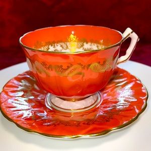 Aynsley rare burnt orange and gold cup and saucer .